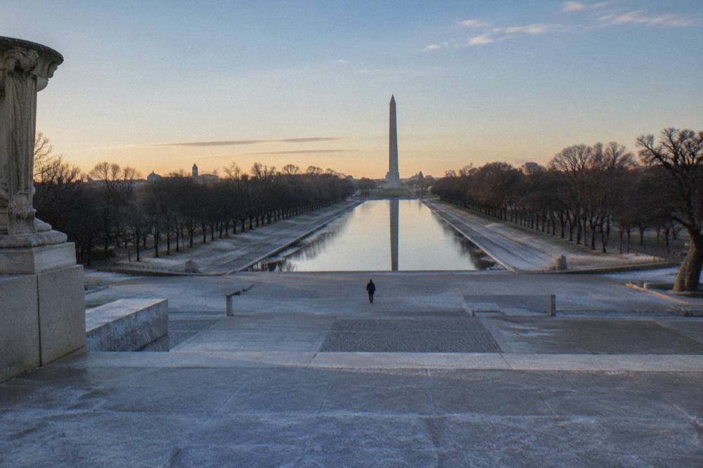 Stone steps of the Lincoln Memorial with the Washington Monument visible in the distance across the Mall