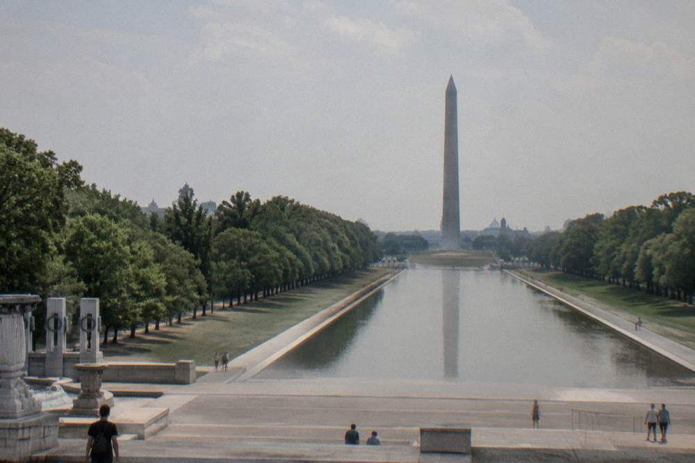 Wide view of the National Mall corridor with memorial grounds on both sides under an open sky