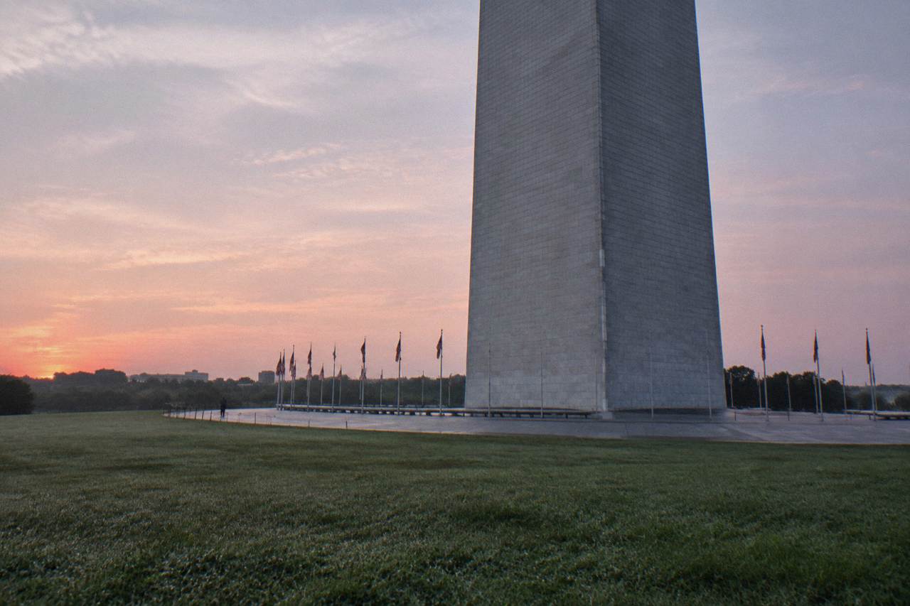 The Washington Monument rising above the National Mall with trees at its base