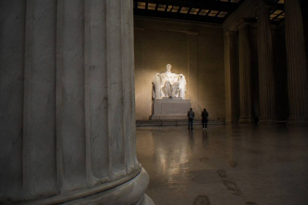 Lincoln Memorial columns and seated Lincoln statue at night
