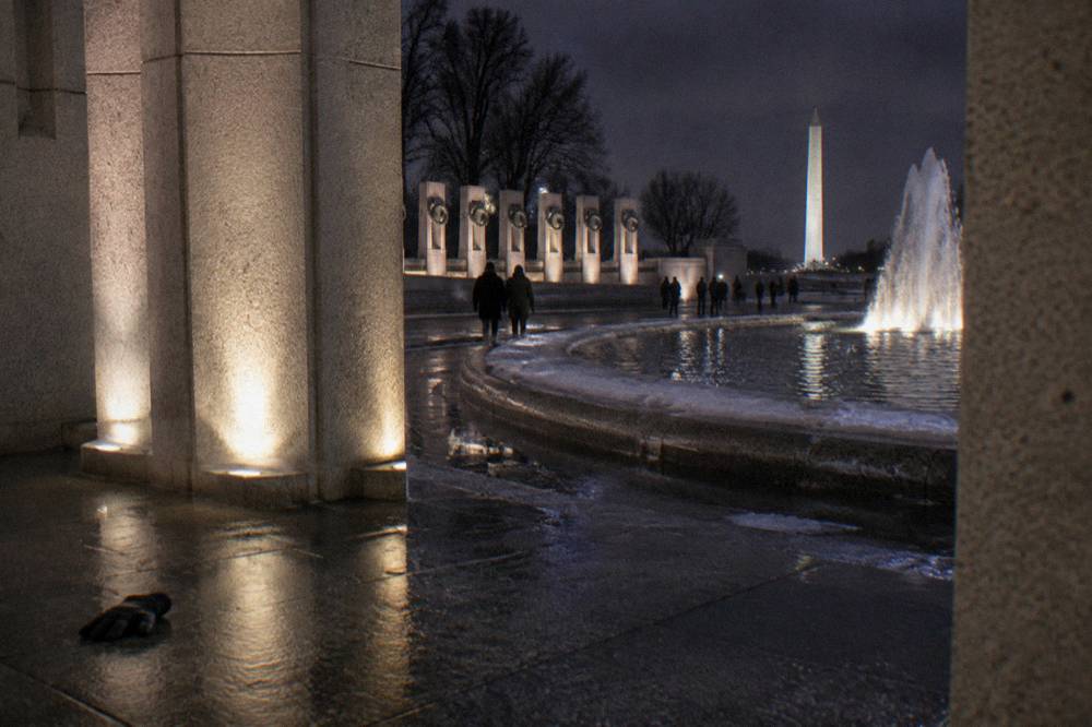 Illuminated memorial columns at night on the National Mall in Washington DC