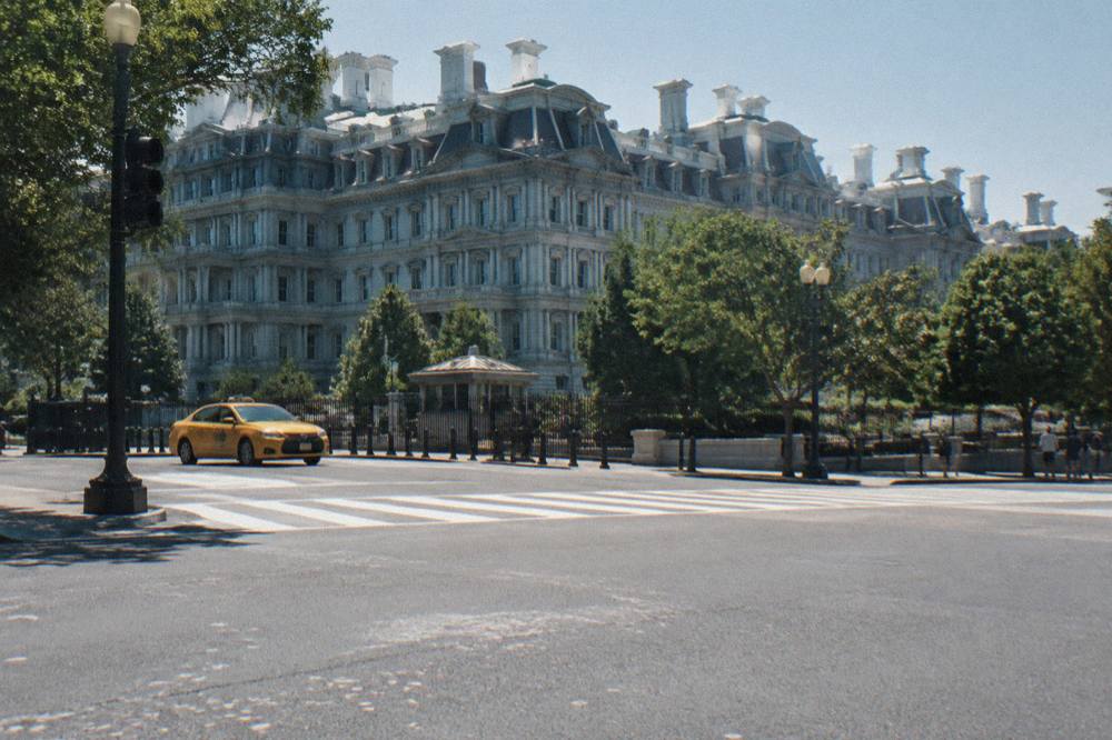 Rows of white government buildings under a clear sky near the White House neighborhood