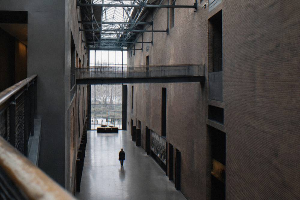 Interior hall of the museum with tall brick walls and industrial steel details