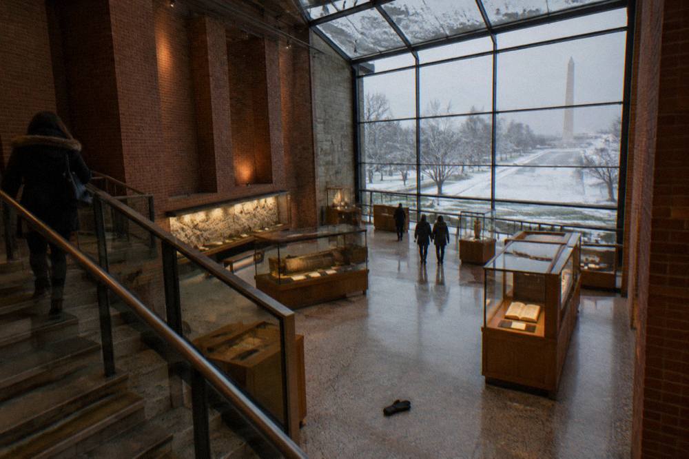 Grand gallery hall inside the Museum of the Bible with tall ceilings and exhibit displays