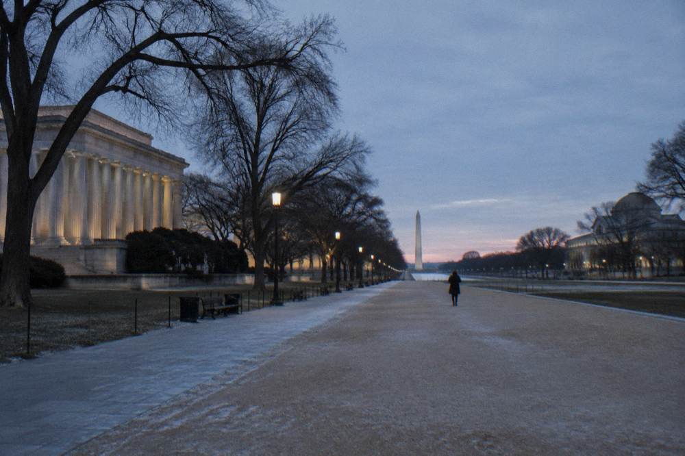 Wide view of the National Mall corridor with museum buildings and trees along a walkway