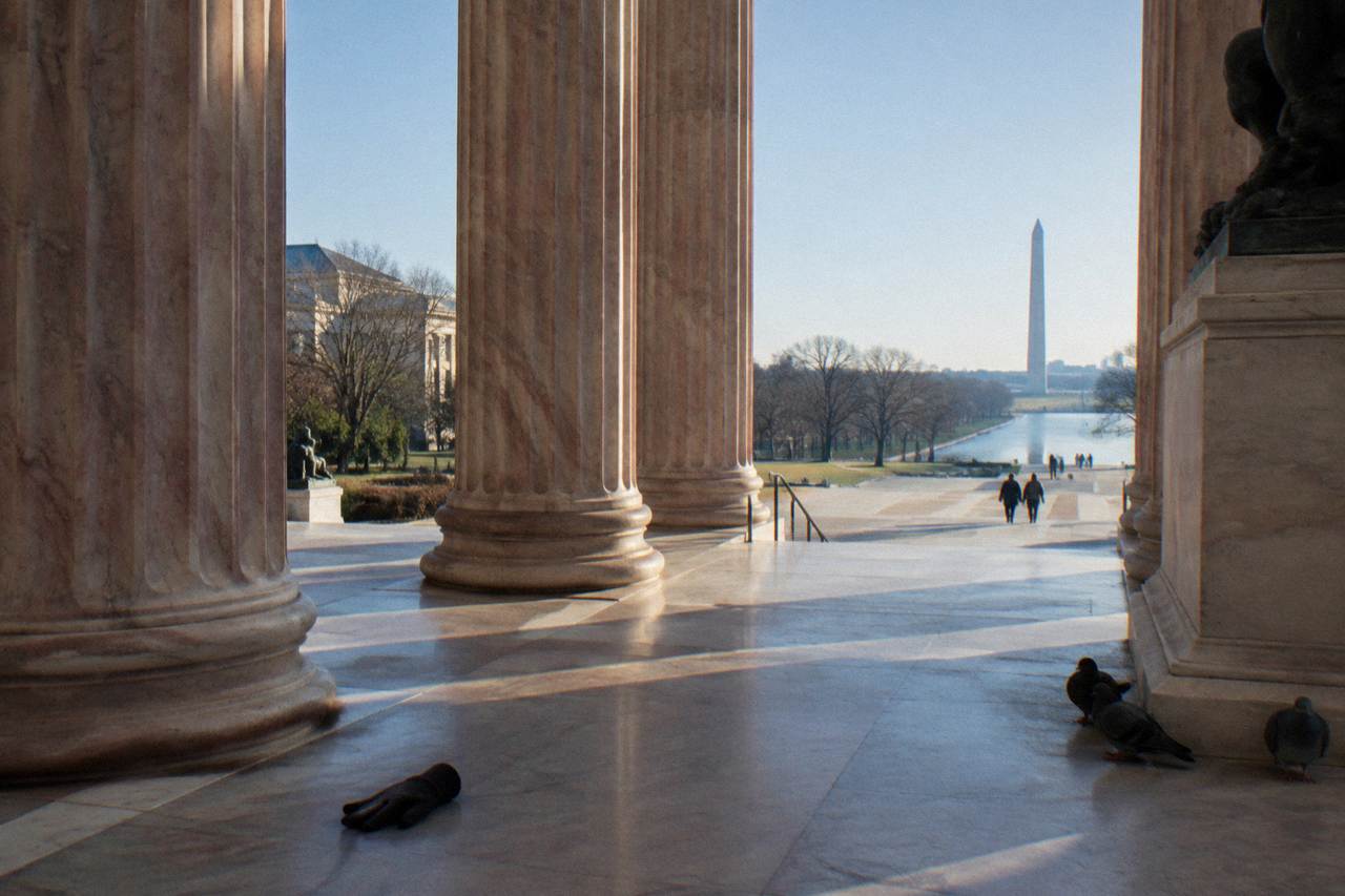 Neoclassical columns of an art museum entrance on a clear day in Washington DC