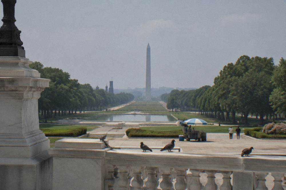 Long view down the National Mall path from the Capitol toward the Washington Monument at midday