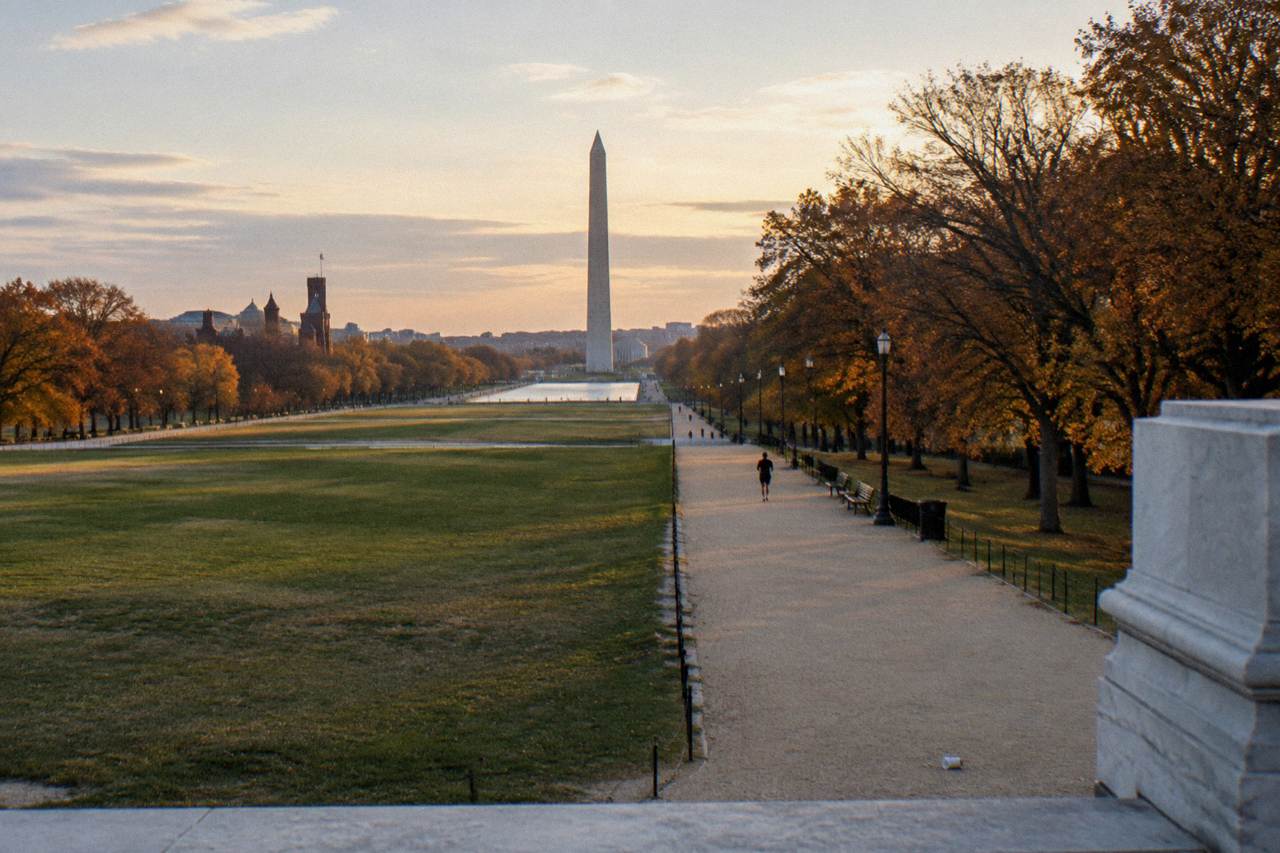 Wide view of the National Mall with the Washington Monument and Capitol building along a tree-lined lawn