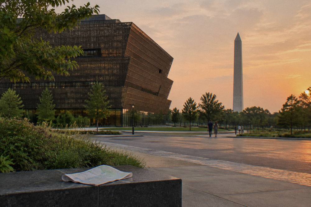 The museum's tiered bronze exterior rising above Madison Drive with the Washington Monument visible behind
