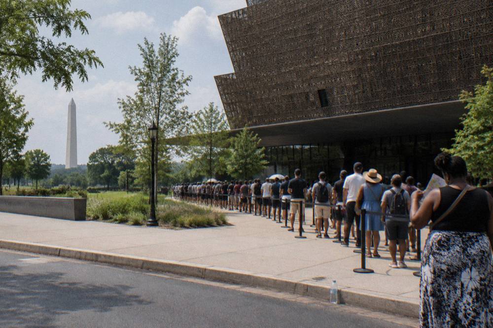 Timed-entry queue outside a Smithsonian museum entrance on a busy afternoon
