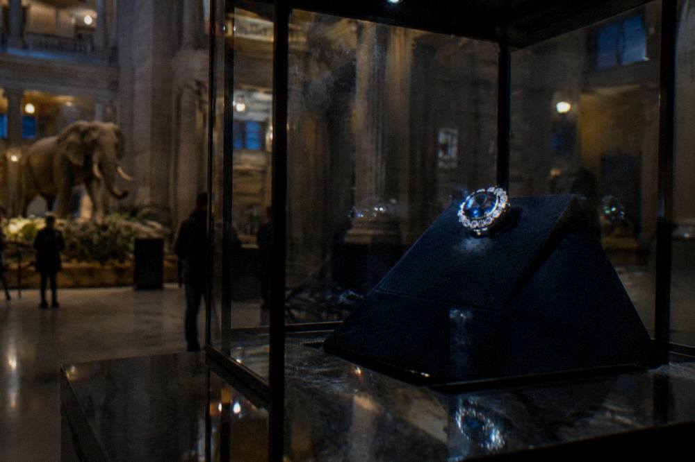 Hope Diamond exhibit glowing blue inside a dark gallery of the Natural History Museum