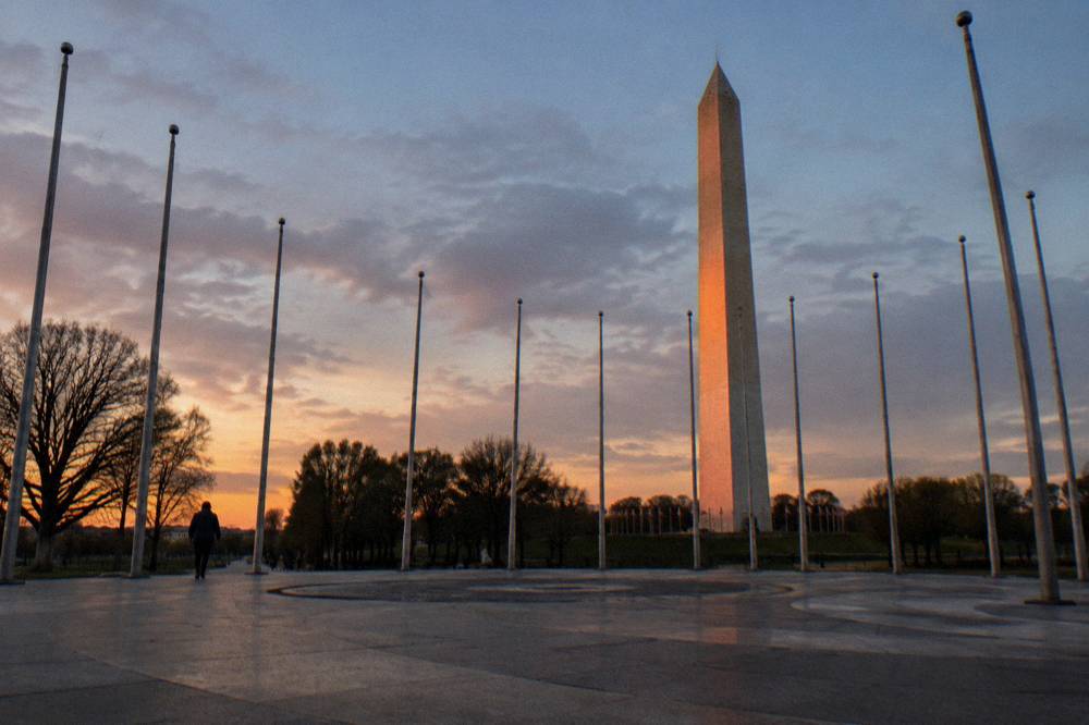 Flags in the circle surrounding the Washington Monument at dusk