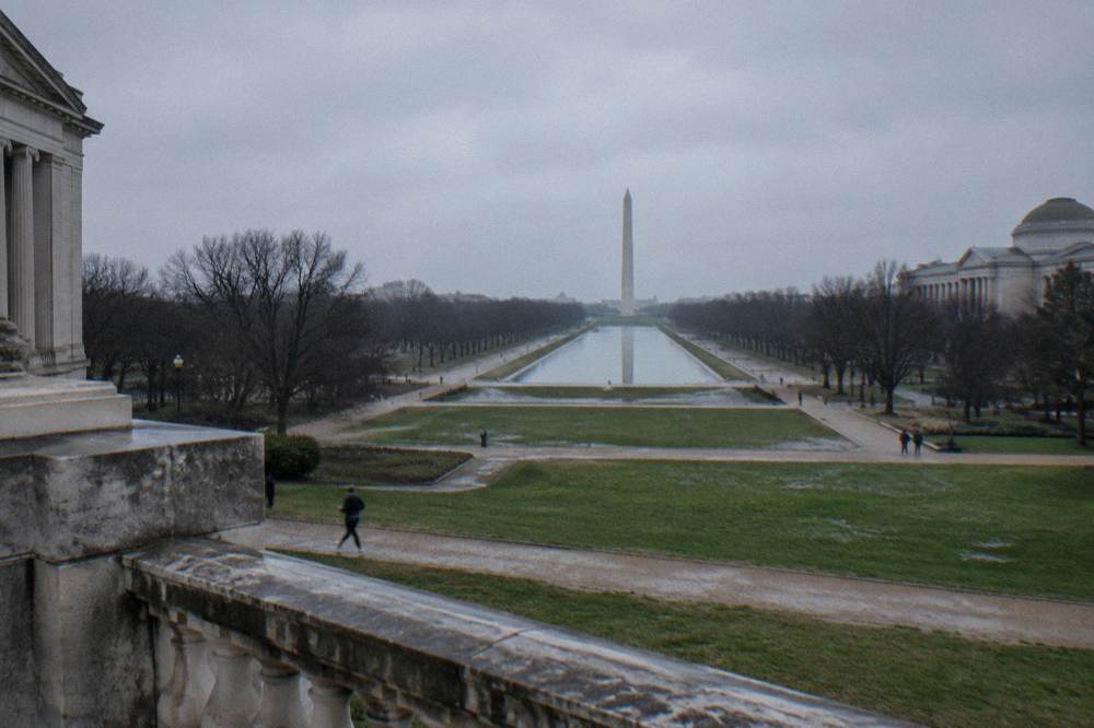 Wide view of museum buildings along the National Mall with walkways and green lawns