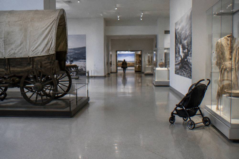 Inside a Smithsonian museum gallery with exhibits and information panels along white walls