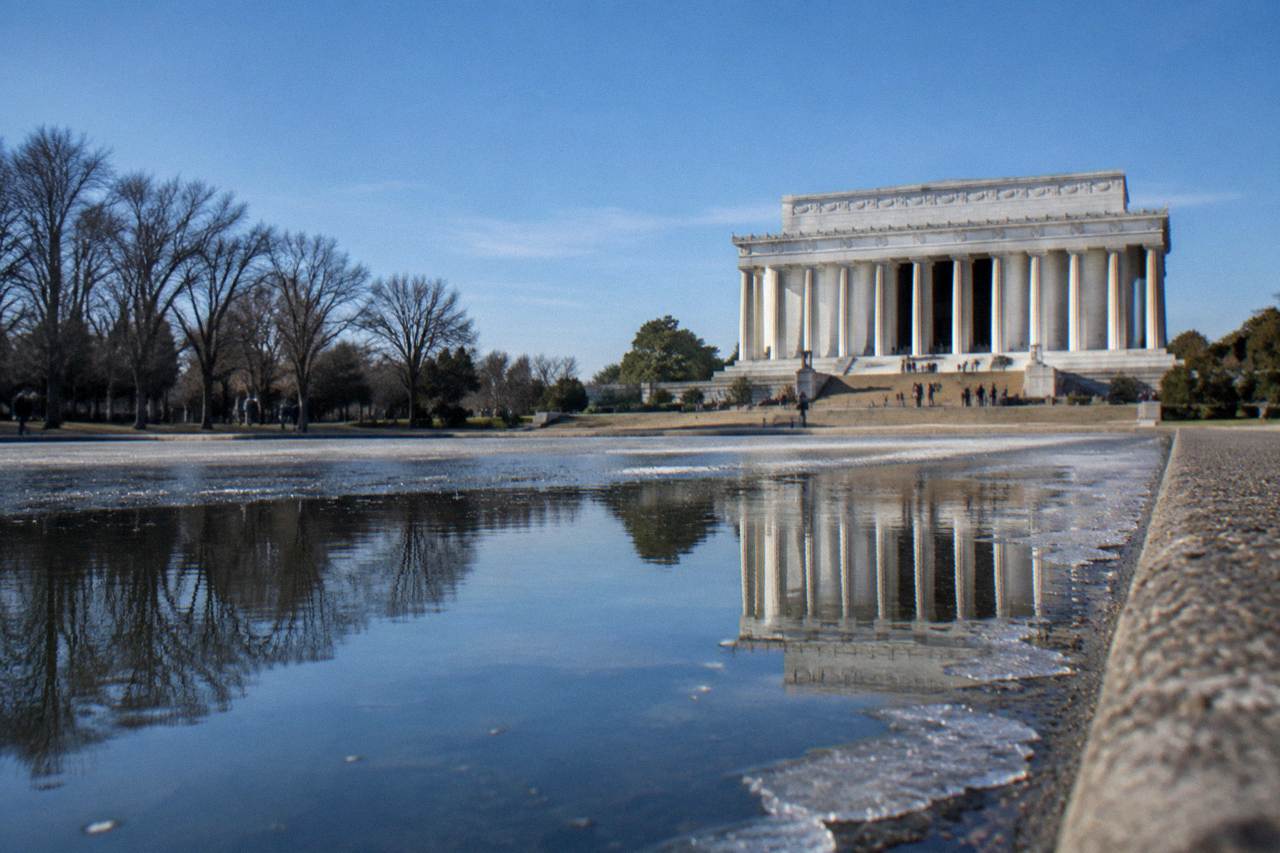 Lincoln Memorial columns and the Reflecting Pool under a clear sky