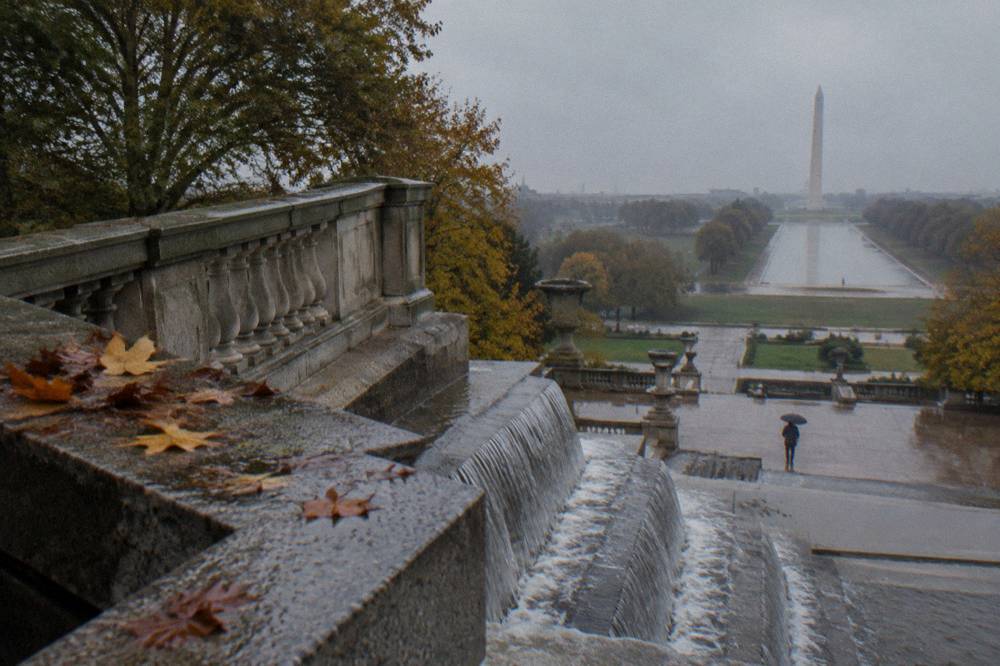 Formal garden terraces with a stone cascade fountain surrounded by trees