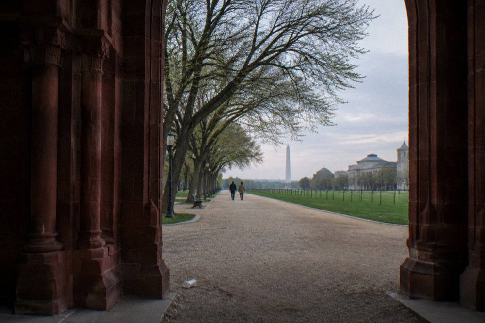 Walking path along the National Mall with trees and museum buildings in the distance