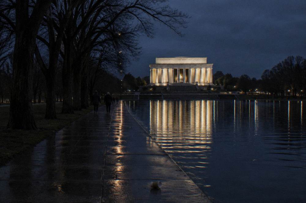 Illuminated Lincoln Memorial reflected in the pool at night